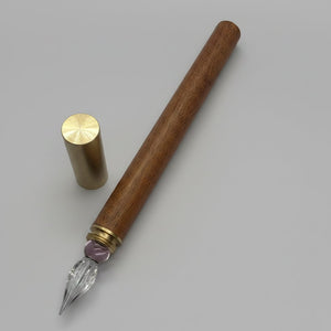 Timber fountain pen with a glass nib with a strip of pink glass.