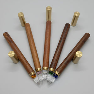 Set of wooden pens with gold accents and on a white background