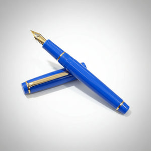 Blue fountain pen with gold accents on a light gray background